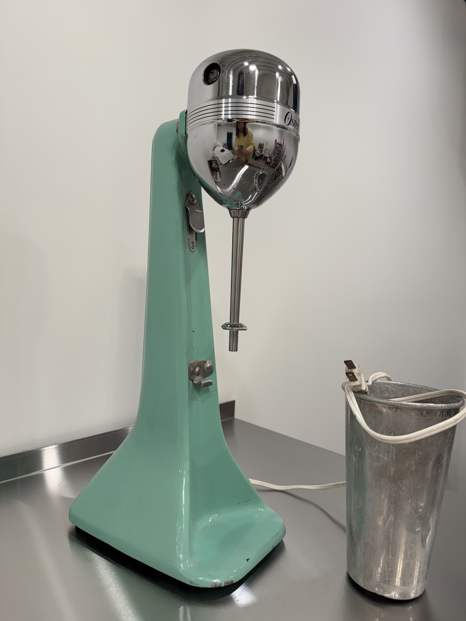 Vintage Oster milkshake mixer with an old aluminum cup